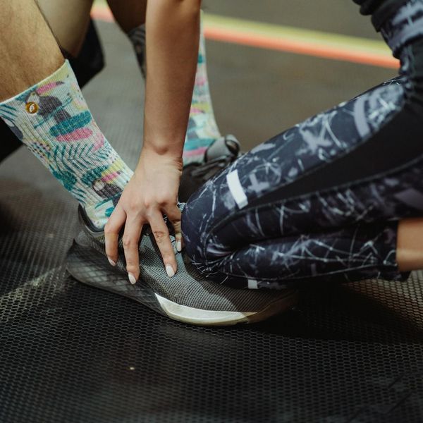 A pair of clean sports shoes on a gym mat