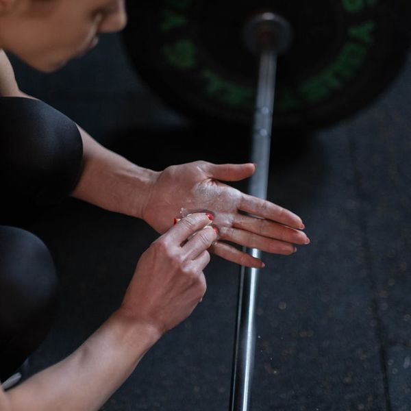 Close up of a person's hands gripping a barbell