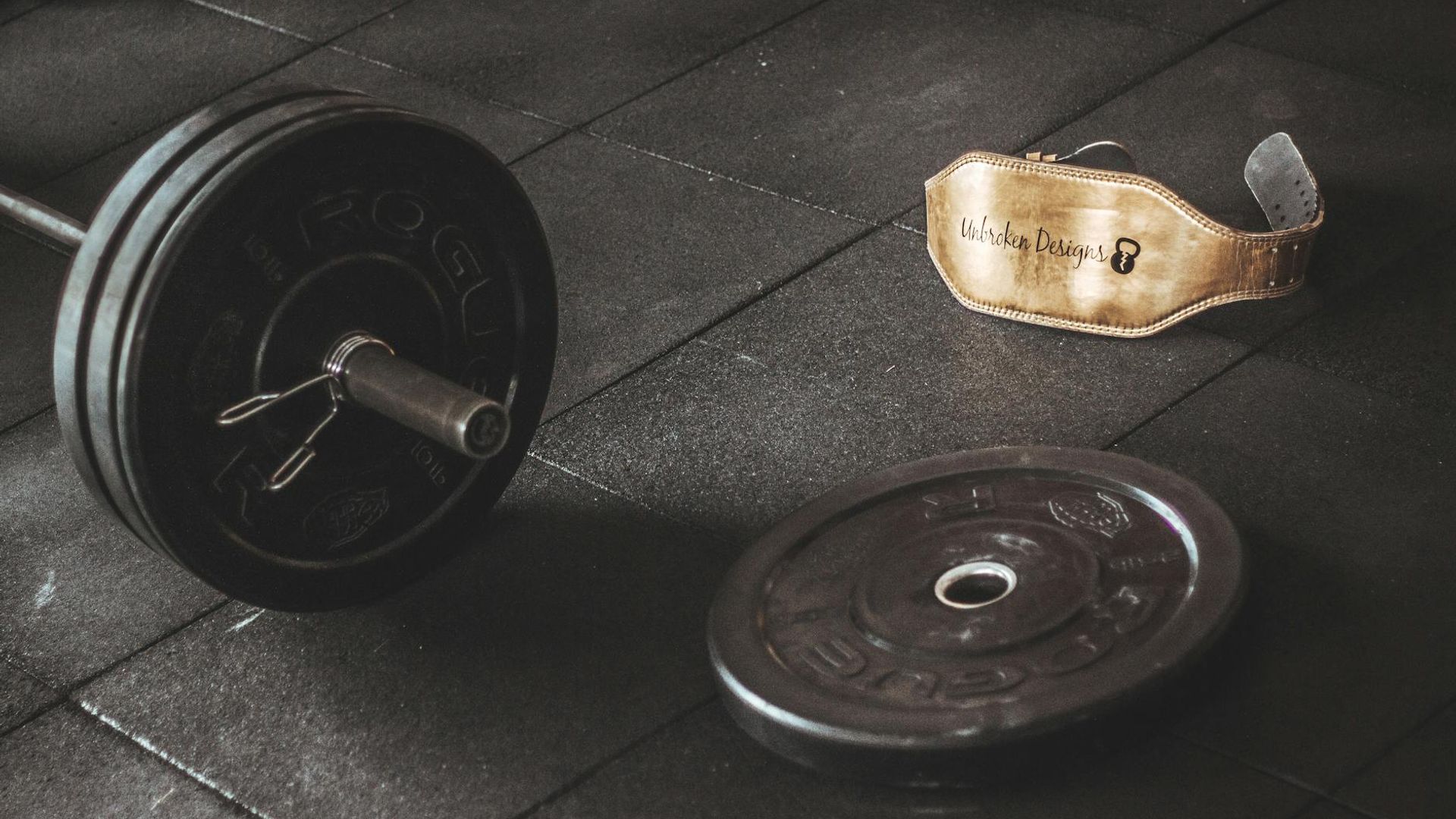 Man lifting heavy weights in a dark modern gym setting